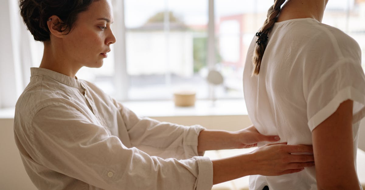 physiotherapist touching womans back