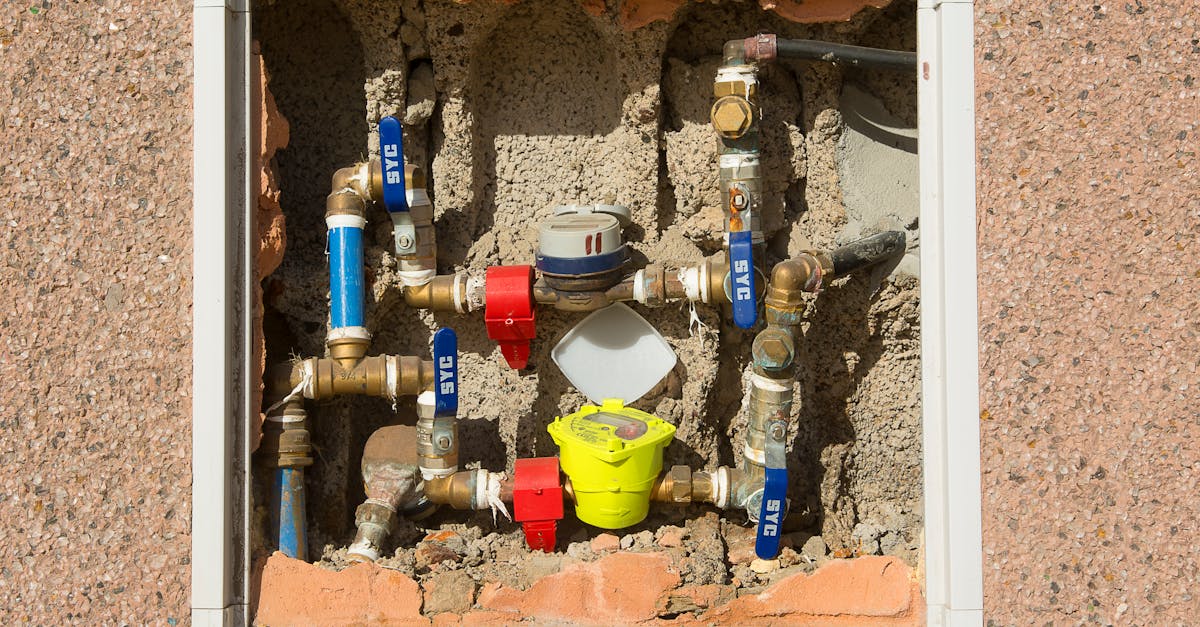 detailed view of a complex water meter setup embedded in a concrete wall